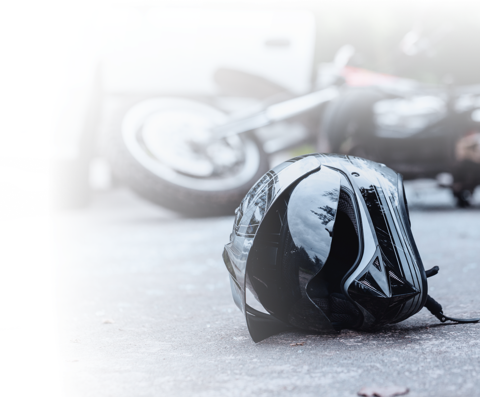 A motorcycle helmet beside a wrecked bike